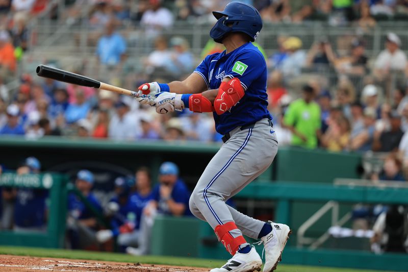 Feb 22, 2026; Fort Myers, Florida, USA;  Toronto Blue Jays infielder Leo Jimenez (49) hits an RBI single during the first inning at JetBlue Park at Fenway South. Mandatory Credit: Kim Klement Neitzel-Imagn Images