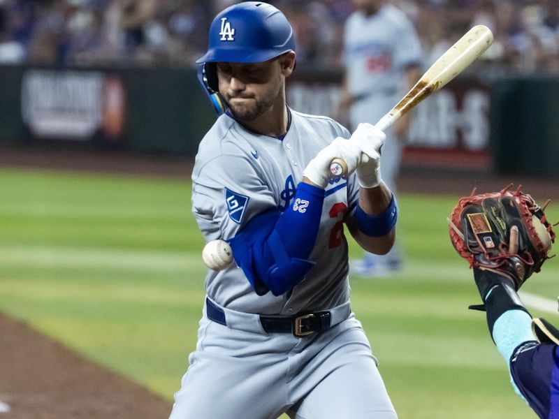 May 9, 2025; Phoenix, Arizona, USA; Los Angeles Dodgers batter Michael Conforto is hit by a pitch in the ninth inning against the Arizona Diamondbacks at Chase Field. Mandatory Credit: Mark J. Rebilas-Imagn Images