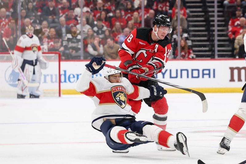 Oct 16, 2025; Newark, New Jersey, USA; New Jersey Devils left wing Ondrej Palat (18) hits Florida Panthers left wing A.J. Greer (10) during the first period at Prudential Center. Mandatory Credit: Ed Mulholland-Imagn Images