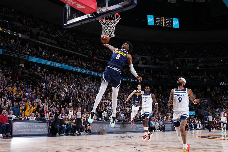 DENVER, CO - APRIL 10: Peyton Watson #8 of the Denver Nuggets dunks the ball during the game against the Minnesota Timberwolves on April 10, 2024 at the Ball Arena in Denver, Colorado. NOTE TO USER: User expressly acknowledges and agrees that, by downloading and/or using this Photograph, user is consenting to the terms and conditions of the Getty Images License Agreement. Mandatory Copyright Notice: Copyright 2024 NBAE (Photo by Garrett Ellwood/NBAE via Getty Images)