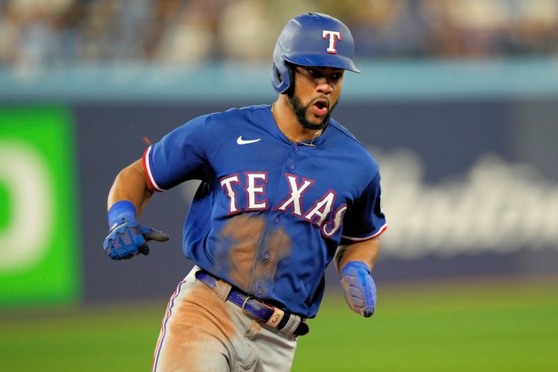 Sep 11, 2023; Toronto, Ontario, CAN; Texas Rangers center fielder Leody Taveras (3) rounds third base to score against the Toronto Blue Jays during the sixth inning at Rogers Centre. Mandatory Credit: John E. Sokolowski-USA TODAY Sports