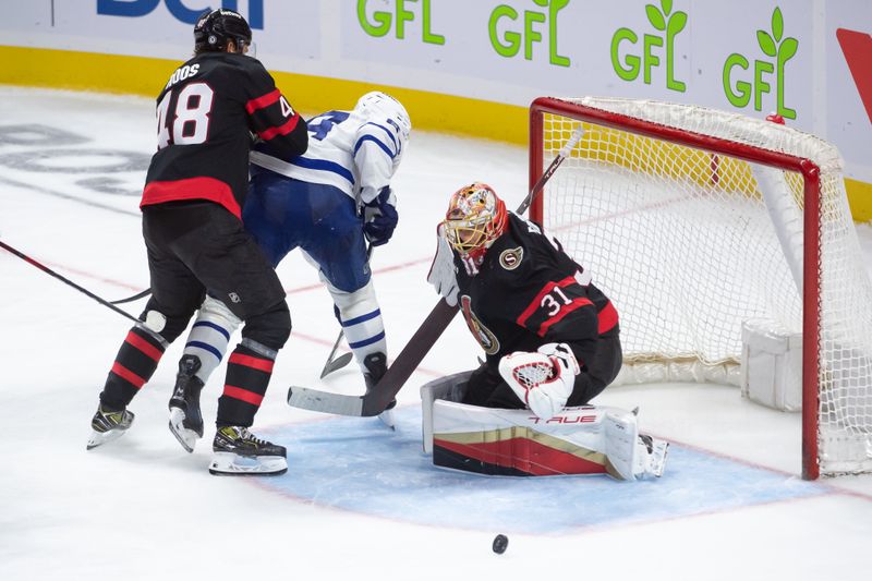 Sep 24, 2024; Ottawa, Ontario, CAN; Ottawa Senators goalie Anton Forsberg (31) makes a save in front of Toronto Maple Leafs center David Kampf (64) in the third period at the Canadian Tire Centre. Mandatory Credit: Marc DesRosiers-Imagn Images