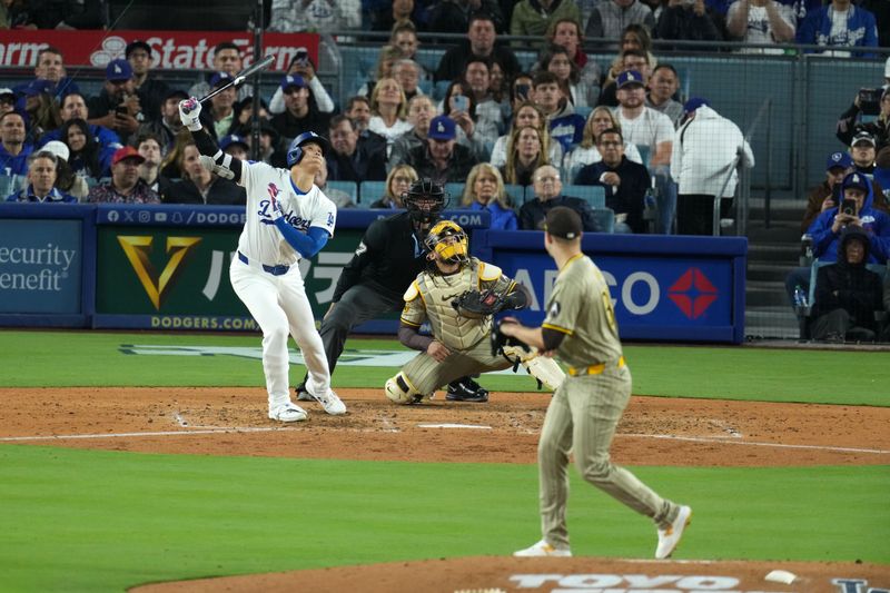 Apr 12, 2024; Los Angeles, California, USA; Los Angeles Dodgers designated hitter Shohei Ohtani (17) hits a double in the fifth inning against San Diego Padres pitcher Michael King (34) at Dodger Stadium. Mandatory Credit: Kirby Lee-USA TODAY Sports