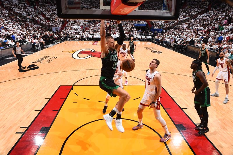 MIAMI, FL - APRIL 27: Kristaps Porzingis #8 of the Boston Celtics dunks the ball during the game against the Miami Heat during Round 1 Game 3 of the 2024 NBA Playoffs on April 27, 2024 at Kaseya Center in Miami, Florida. NOTE TO USER: User expressly acknowledges and agrees that, by downloading and or using this Photograph, user is consenting to the terms and conditions of the Getty Images License Agreement. Mandatory Copyright Notice: Copyright 2024 NBAE (Photo by Brian Babineau/NBAE via Getty Images)