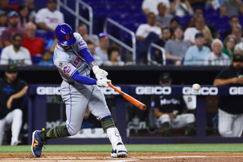 May 17, 2024; Miami, Florida, USA; New York Mets shortstop Francisco Lindor (12) hits a single against the Miami Marlins during the first inning at loanDepot Park. Mandatory Credit: Sam Navarro-USA TODAY Sports