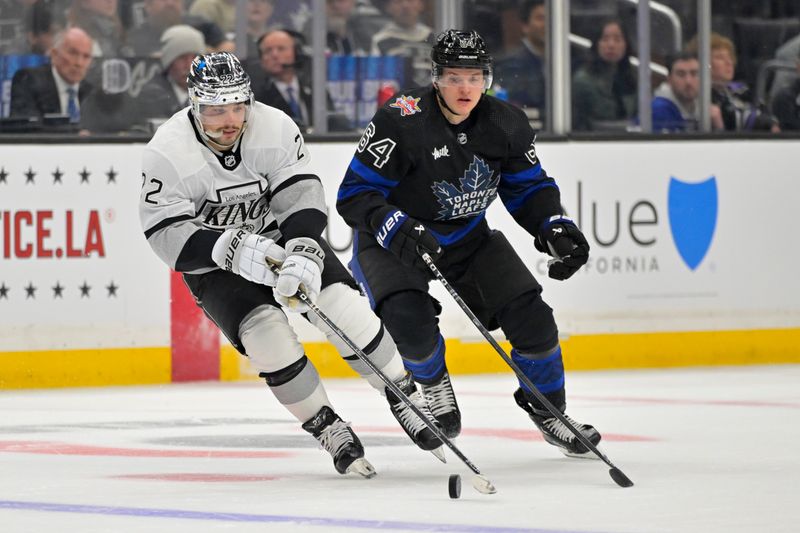 Jan 2, 2024; Los Angeles, California, USA; Los Angeles Kings left wing Kevin Fiala (22) skates the puck past Toronto Maple Leafs center David Kampf (64) in the second period at Crypto.com Arena. Mandatory Credit: Jayne Kamin-Oncea-USA TODAY Sports