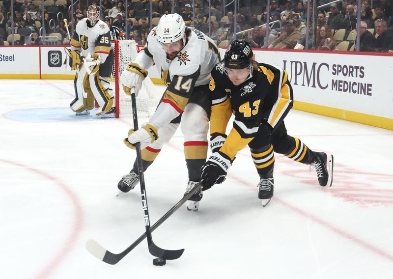 Mar 11, 2025; Pittsburgh, Pennsylvania, USA;  Vegas Golden Knights defenseman Nicolas Hague (14) and Pittsburgh Penguins left wing Danton Heinen (43) battle for the puck during the first period at PPG Paints Arena. Mandatory Credit: Charles LeClaire-Imagn Images