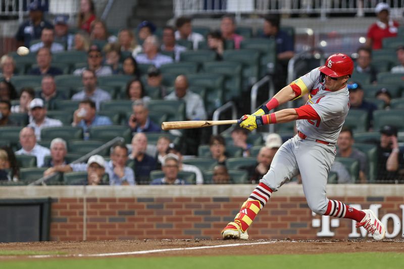 Apr 22, 2025; Cumberland, Georgia, USA; St. Louis Cardinals outfielder Lars Nootbaar (21) hits a home run against the Atlanta Braves during the third inning at Truist Park. Mandatory Credit: Jordan Godfree-Imagn Images