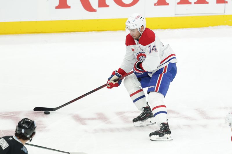 Jan 14, 2025; Salt Lake City, Utah, USA;  Montreal Canadiens center Nick Suzuki (14) controls the puck during the first period against the Utah Hockey Club at Delta Center. Mandatory Credit: Chris Nicoll-Imagn Images