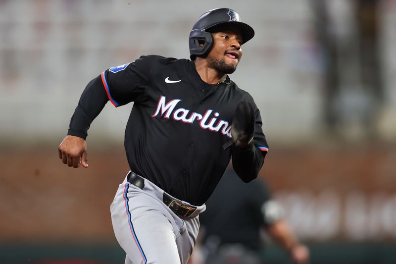 Aug 3, 2024; Atlanta, Georgia, USA; Miami Marlins shortstop Xavier Edwards (63) runs to third against the Atlanta Braves in the ninth inning at Truist Park. Mandatory Credit: Brett Davis-USA TODAY Sports