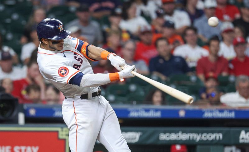 Jun 4, 2024; Houston, Texas, USA; Houston Astros shortstop Jeremy Pena (3) hits an RBI double during the third inning against the St. Louis Cardinals at Minute Maid Park. Mandatory Credit: Troy Taormina-USA TODAY Sports