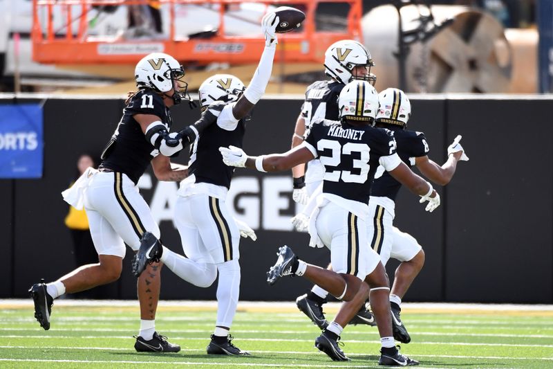 Oct 14, 2023; Nashville, Tennessee, USA; Vanderbilt Commodores defenders celebrate after recovering a fumble during the first half against the Georgia Bulldogs at FirstBank Stadium. Mandatory Credit: Christopher Hanewinckel-USA TODAY Sports