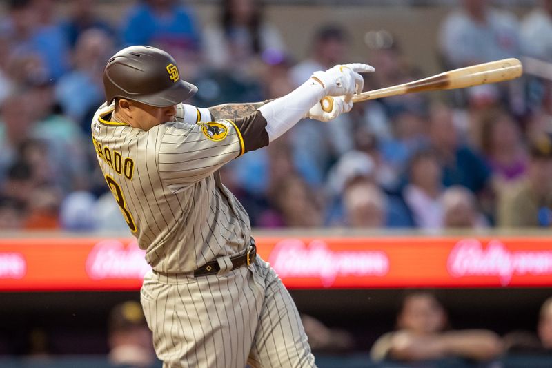 May 10, 2023; Minneapolis, Minnesota, USA; San Diego Padres third baseman Manny Machado (13) hits a RBI sacrifice fly in the eighth inning against the Minnesota Twins at Target Field. Mandatory Credit: Jesse Johnson-USA TODAY Sports