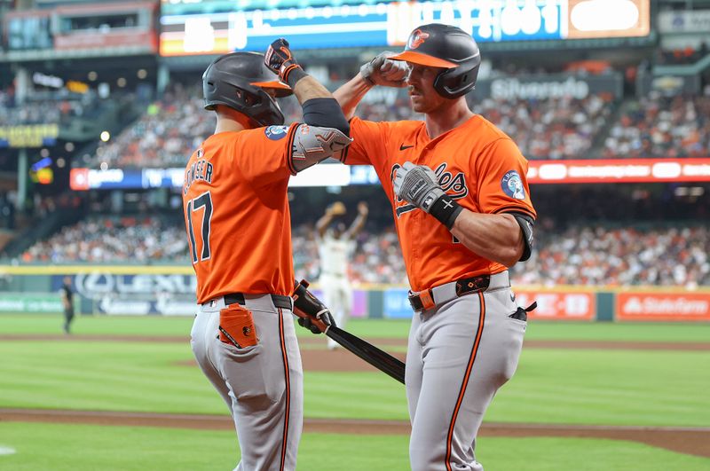 Jun 22, 2024; Houston, Texas, USA; Baltimore Orioles second baseman Jordan Westburg (11) celebrates with right fielder Colton Cowser (17) after hitting a home run during the second inning against the Houston Astros at Minute Maid Park. Mandatory Credit: Troy Taormina-USA TODAY Sports