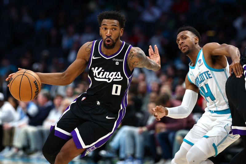 CHARLOTTE, NORTH CAROLINA - JANUARY 10: Malik Monk #0 of the Sacramento Kings drives to the basket against Ish Smith #14 of the Charlotte Hornets during the second half of the game at Spectrum Center on January 10, 2024 in Charlotte, North Carolina. NOTE TO USER: User expressly acknowledges and agrees that, by downloading and or using this photograph, User is consenting to the terms and conditions of the Getty Images License Agreement.<p><br/></p> (Photo by Jared C. Tilton/Getty Images)