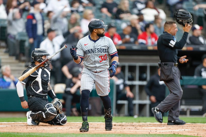 Apr 29, 2024; Chicago, Illinois, USA; Minnesota Twins first baseman Carlos Santana (30) watches his two-run home run against the Chicago White Sox during the second inning at Guaranteed Rate Field. Mandatory Credit: Kamil Krzaczynski-USA TODAY Sports