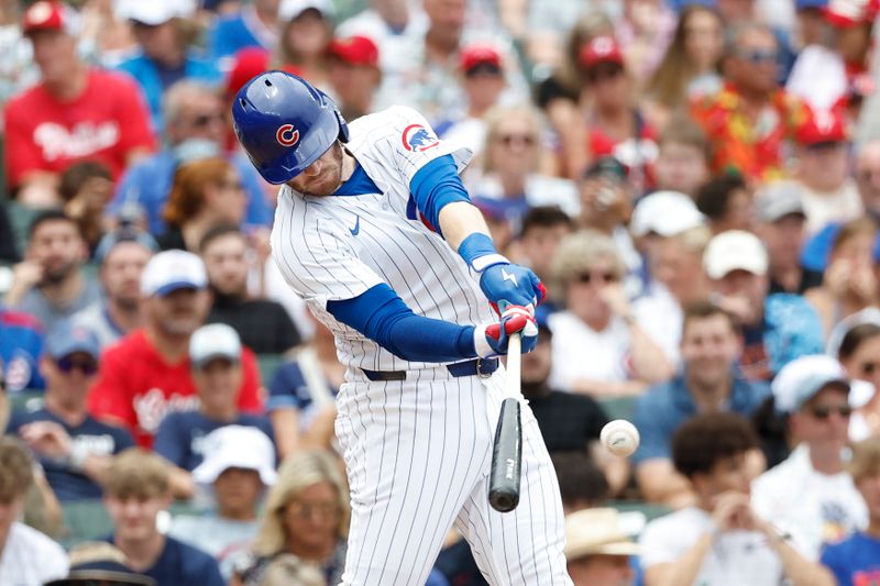 Jul 4, 2024; Chicago, Illinois, USA; Chicago Cubs outfielder Ian Happ (8) singles against the Philadelphia Phillies during the second inning at Wrigley Field. Mandatory Credit: Kamil Krzaczynski-USA TODAY Sports