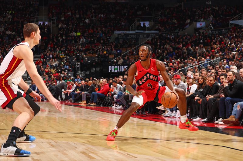 TORONTO, CANADA - JANUARY 17: Immanuel Quickley #5 of the Toronto Raptors dribbles the ball during the game against the Miami Heat on January 17, 2024 at the Scotiabank Arena in Toronto, Ontario, Canada.  NOTE TO USER: User expressly acknowledges and agrees that, by downloading and or using this Photograph, user is consenting to the terms and conditions of the Getty Images License Agreement.  Mandatory Copyright Notice: Copyright 2024 NBAE (Photo by Vaughn Ridley/NBAE via Getty Images)