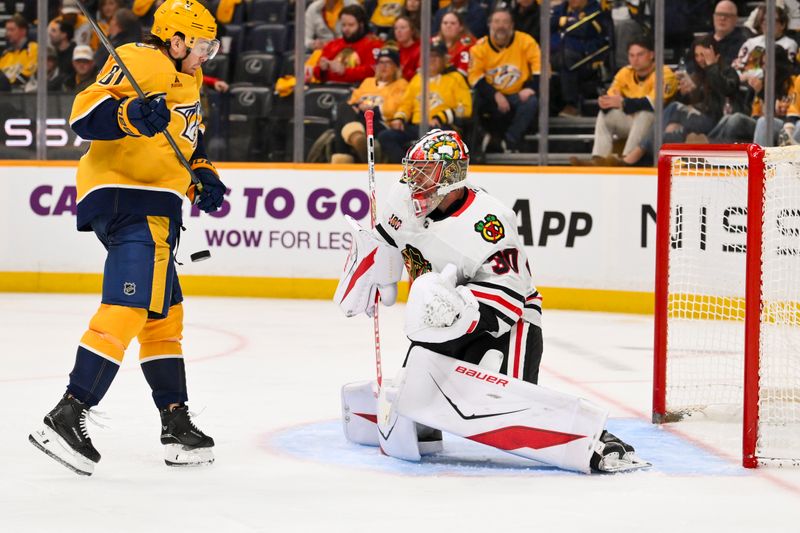 Feb 26, 2026; Nashville, Tennessee, USA;  Chicago Blackhawks goaltender Spencer Knight (30) blocks the deflection from Nashville Predators center Jonathan Marchessault (81) during the third period at Bridgestone Arena. Mandatory Credit: Steve Roberts-Imagn Images