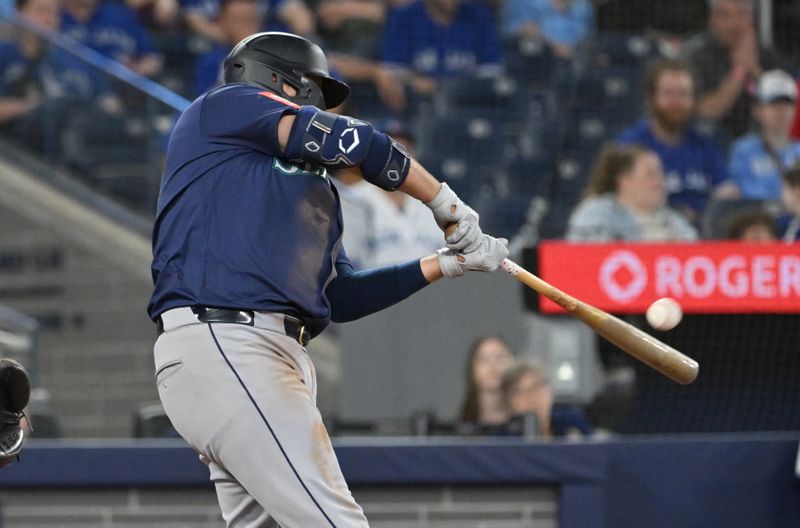 Apr 19, 2025; Toronto, Ontario, CAN;  Seattle Mariners first baseman Rowdy Tellez (23) hits a grand slam home run against the Toronto Blue Jays in the 12th inning at Rogers Centre. Mandatory Credit: Dan Hamilton-Imagn Images