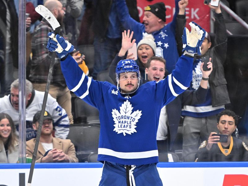 Dec 2, 2023; Toronto, Ontario, CAN; Toronto Maple Leafs forward Auston Matthews (34) celebrates after scoring against the Boston Bruins in the third period at Scotiabank Arena. Mandatory Credit: Dan Hamilton-USA TODAY Sports