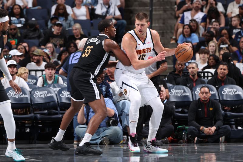 MEMPHIS, TN - APRIL 14:  Nikola Jokic #15 of the Denver Nuggets handles the ball during the game against the Memphis Grizzlies on April 14, 2024 at FedExForum in Memphis, Tennessee. NOTE TO USER: User expressly acknowledges and agrees that, by downloading and or using this photograph, User is consenting to the terms and conditions of the Getty Images License Agreement. Mandatory Copyright Notice: Copyright 2024 NBAE (Photo by Joe Murphy/NBAE via Getty Images)