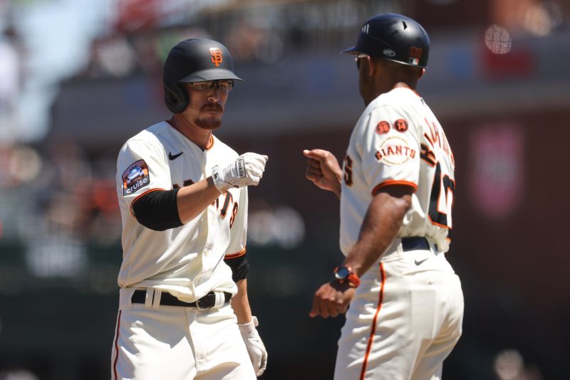 Aug 16, 2023; San Francisco, California, USA; San Francisco Giants right fielder Wade Meckler (53) fist pumps first base coach Antoan Richardson (0) after hitting a single during the third inning against the Tampa Bay Rays at Oracle Park. Mandatory Credit: Sergio Estrada-USA TODAY Sports