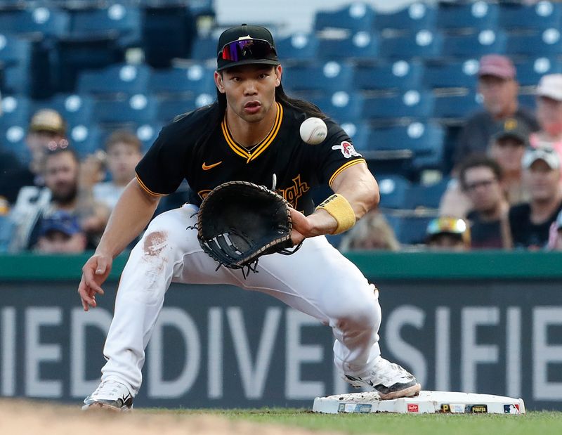 May 22, 2024; Pittsburgh, Pennsylvania, USA;  Pittsburgh Pirates first baseman Connor Joe (2) takes a throw at first base to record an out against the San Francisco Giants during the fourth inning at PNC Park. Mandatory Credit: Charles LeClaire-USA TODAY Sports