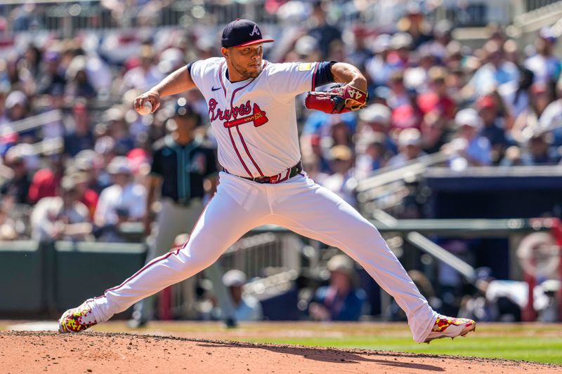 Apr 7, 2024; Cumberland, Georgia, USA; Atlanta Braves relief pitcher Joe Jimenez (77) pitches against the Arizona Diamondbacks during the sixth inning at Truist Park. Mandatory Credit: Dale Zanine-USA TODAY Sports