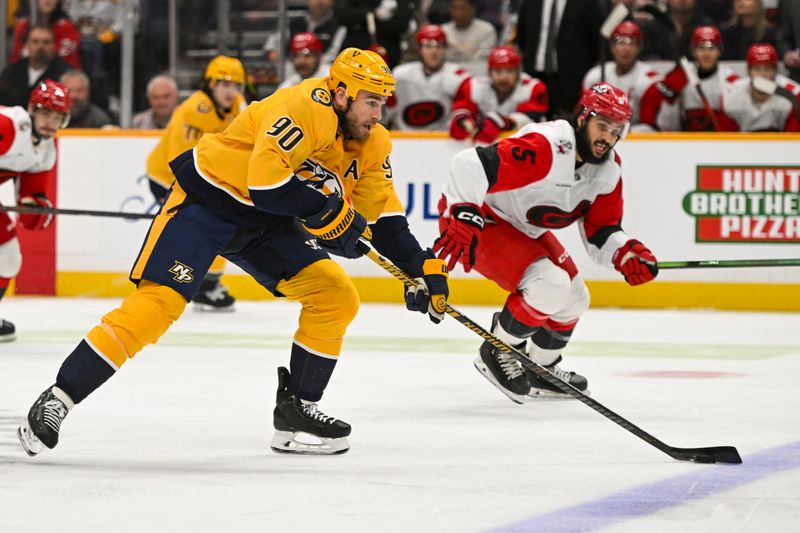 Dec 17, 2025; Nashville, Tennessee, USA;  Nashville Predators center Ryan O'Reilly (90) skates with the puck against the Carolina Hurricanes during the first period at Bridgestone Arena. Mandatory Credit: Steve Roberts-Imagn Images
