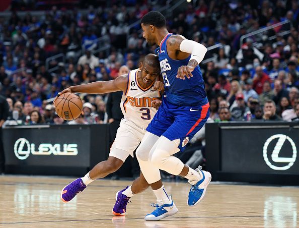 LOS ANGELES, CA - OCTOBER 23: Chris Paul #3 of the Phoenix Suns drives against Paul George #13 of the Los Angeles Clippers during the second half at Crypto.com Arena on October 23, 2022 in Los Angeles, California. NOTE TO USER: User expressly acknowledges and agrees that, by downloading and or using this photograph, User is consenting to the terms and conditions of the Getty Images License Agreement. (Photo by Kevork Djansezian/Getty Images)