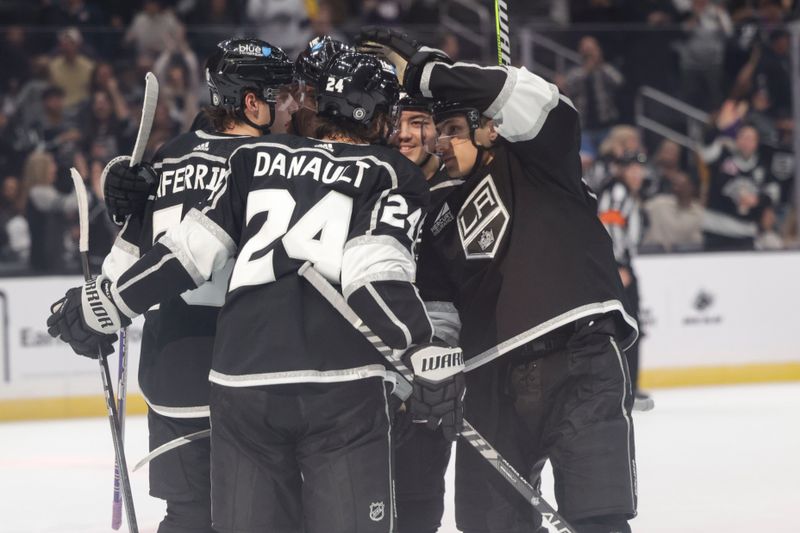 Oct 14, 2023; Los Angeles, California, USA; Los Angeles Kings Center Phillip Danault (24) celebrates with his team members after Los Angeles Kings Left Wing Trevor Moore (12) during the second period at Crypto.com Arena. Mandatory Credit: Yannick Peterhans-USA TODAY Sports