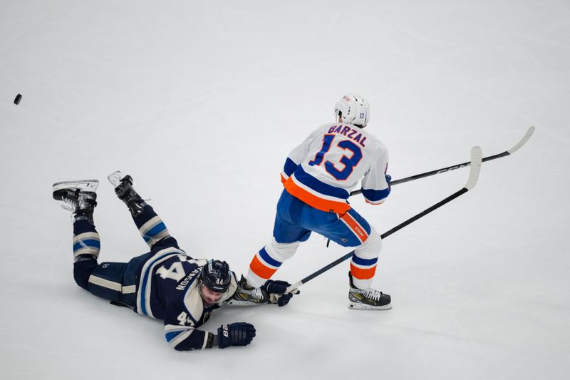 Apr 4, 2024; Columbus, Ohio, USA;  Columbus Blue Jackets defenseman Erik Gudbranson (44) dives for the puck against New York Islanders center Mathew Barzal (13) in the first period at Nationwide Arena. Mandatory Credit: Aaron Doster-USA TODAY Sports