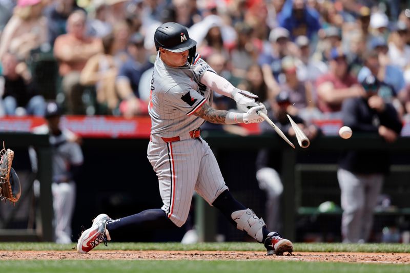Jun 30, 2024; Seattle, Washington, USA; Minnesota Twins designated hitter Jose Miranda (64) breaks his bat on an RBI single against the Seattle Mariners during the fifth inning at T-Mobile Park. Mandatory Credit: John Froschauer-USA TODAY Sports