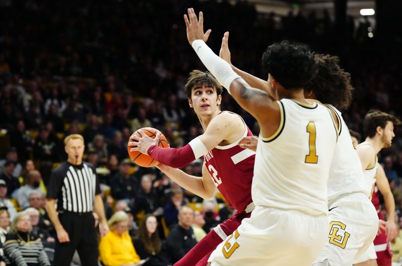 Feb 5, 2023; Boulder, Colorado, USA; Stanford Cardinal forward Maxime Raynaud (42) looks to pass the ball away from Colorado Buffaloes guard Javon Ruffin (11) and guard Julian Hammond III (1) in the second halfat the CU Events Center. Mandatory Credit: Ron Chenoy-USA TODAY Sports