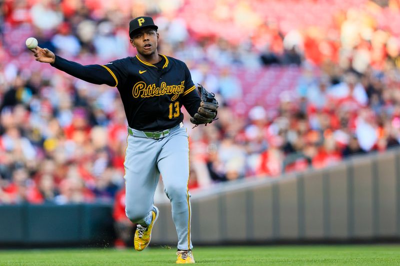 Apr 12, 2025; Cincinnati, Ohio, USA; Pittsburgh Pirates third baseman Ke'Bryan Hayes (13) throws to first to get Cincinnati Reds outfielder TJ Friedl (not pictured) out in the first inning at Great American Ball Park. Mandatory Credit: Katie Stratman-Imagn Images