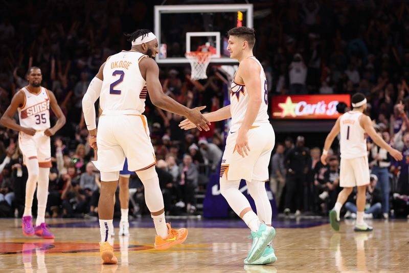 PHOENIX, ARIZONA - DECEMBER 25: Grayson Allen #8 of the Phoenix Suns celebrates with Josh Okogie #2 during the second half of the NBA game at Footprint Center on December 25, 2023 in Phoenix, Arizona. The Mavericks defeated the Suns 128-114. NOTE TO USER: User expressly acknowledges and agrees that, by downloading and or using this photograph, User is consenting to the terms and conditions of the Getty Images License Agreement.  (Photo by Christian Petersen/Getty Images)