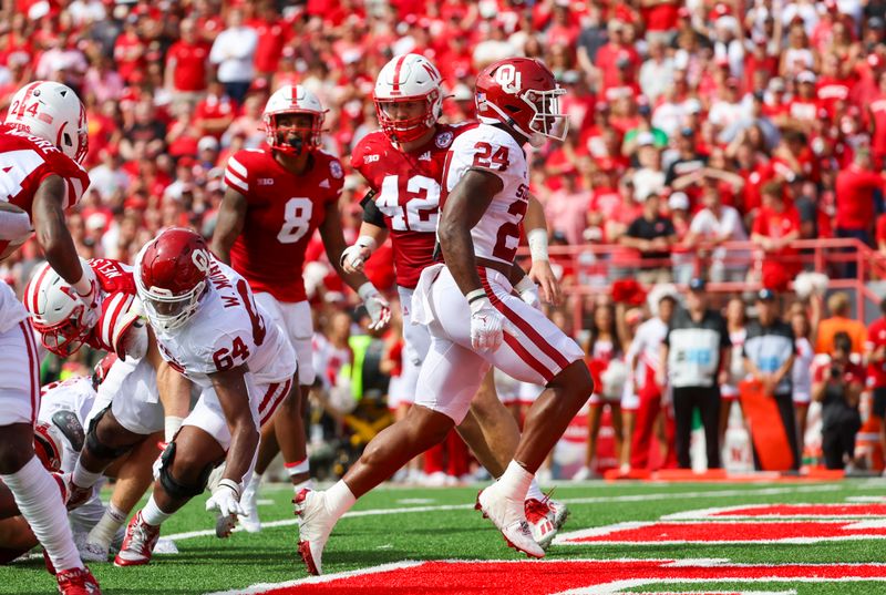 Sep 17, 2022; Lincoln, Nebraska, USA;  Oklahoma Sooners running back Marcus Major (24) scores a touchdown during the first half against the Nebraska Cornhuskers at Memorial Stadium. Mandatory Credit: Kevin Jairaj-USA TODAY Sports