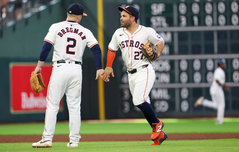 Jun 23, 2024; Houston, Texas, USA;  Houston Astros third baseman Alex Bregman (2) and second baseman Jose Altuve (27) celebrate after defeating the Baltimore Orioles at Minute Maid Park. Mandatory Credit: Thomas Shea-USA TODAY Sports