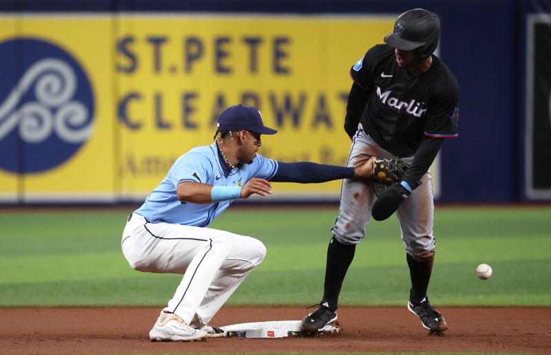 Jul 30, 2024; St. Petersburg, Florida, USA; Miami Marlins shortstop Xavier Edwards (63) steals second base as Tampa Bay Rays infielder Christopher Morel (24) attempts to tag him out at Tropicana Field. Mandatory Credit: Kim Klement Neitzel-USA TODAY Sports