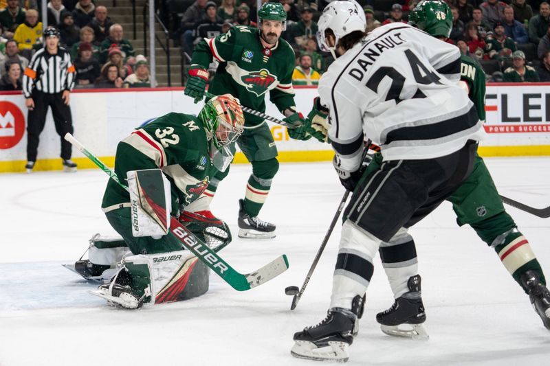 Feb 21, 2023; Saint Paul, Minnesota, USA; Minnesota Wild goaltender Filip Gustavsson (32)  defenseman Jared Spurgeon (46) and Los Angeles Kings center Phillip Danault (24) fight for the rebound in the third period at Xcel Energy Center. Mandatory Credit: Matt Blewett-USA TODAY Sports