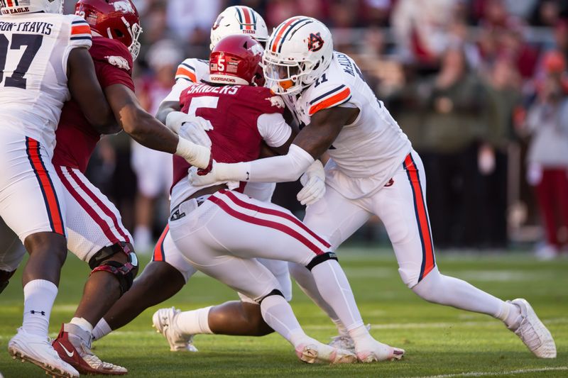 Nov 11, 2023; Fayetteville, Arkansas, USA;  Auburn Tigers linebacker Elijah McAllister (11) tackles Arkansas Razorbacks running back Raheim Sanders (5) during the second quarter at Donald W. Reynolds Razorback Stadium. Mandatory Credit: Brett Rojo-USA TODAY Sports