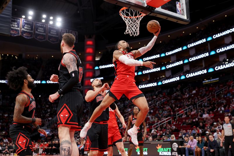 HOUSTON, TEXAS - MARCH 21: Dillon Brooks #9 of the Houston Rockets goes up for a lay up against Nikola Vucevic #9 of the Chicago Bulls in the first half at Toyota Center on March 21, 2024 in Houston, Texas.  NOTE TO USER: User expressly acknowledges and agrees that, by downloading and or using this photograph, User is consenting to the terms and conditions of the Getty Images License Agreement. (Photo by Tim Warner/Getty Images)