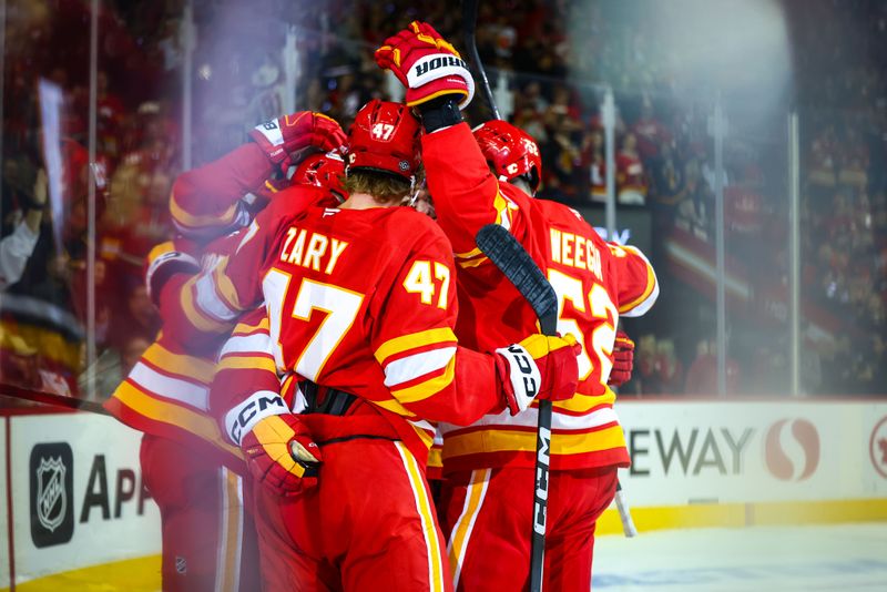 Oct 12, 2024; Calgary, Alberta, CAN; Calgary Flames center Nazem Kadri (91) celebrates his goal with teammates against the Philadelphia Flyers during the second period at Scotiabank Saddledome. Mandatory Credit: Sergei Belski-Imagn Images