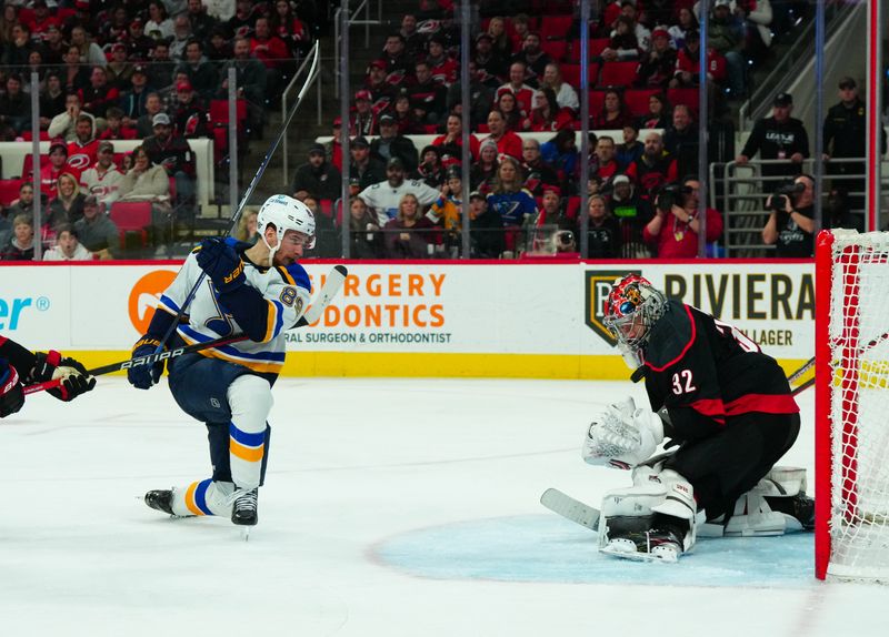 Jan 6, 2024; Raleigh, North Carolina, USA; Carolina Hurricanes goaltender Antti Raanta (32) stops the shot attempt by St. Louis Blues left wing Pavel Buchnevich (89) during the second period at PNC Arena. Mandatory Credit: James Guillory-USA TODAY Sports