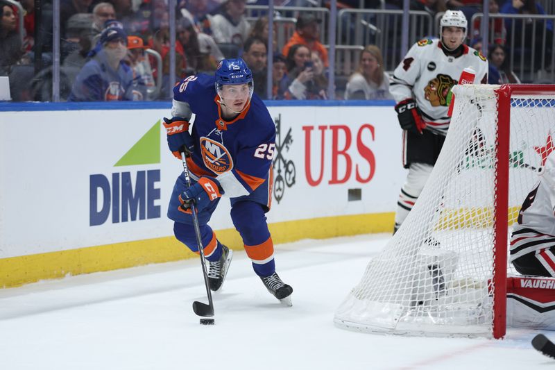 Apr 2, 2024; Elmont, New York, USA; New York Islanders defenseman Sebastian Aho (25) skates with the puck against the Chicago Blackhawks during the second period at UBS Arena. Mandatory Credit: Thomas Salus-USA TODAY Sports