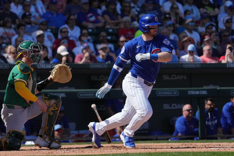Mar 7, 2026; Mesa, Arizona, USA; Chicago Cubs left fielder Ian Happ (8) hits a single against the Athletics in the first inning at Sloan Park. Mandatory Credit: Rick Scuteri-Imagn Images