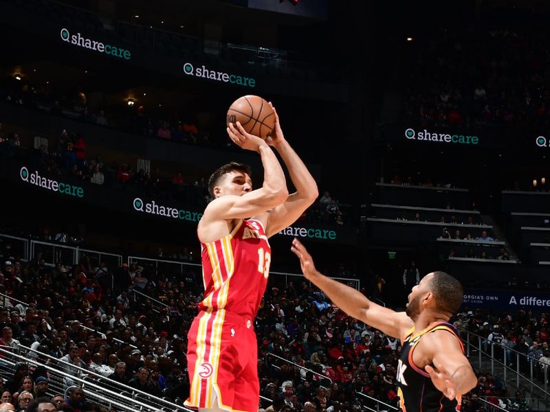 ATLANTA, GA - FEBRUARY 2: Bogdan Bogdanovic #13 of the Atlanta Hawks shoots a three point basket against the Phoenix Suns on February 2, 2024 at State Farm Arena in Atlanta, Georgia.  NOTE TO USER: User expressly acknowledges and agrees that, by downloading and/or using this Photograph, user is consenting to the terms and conditions of the Getty Images License Agreement. Mandatory Copyright Notice: Copyright 2024 NBAE (Photo by Scott Cunningham/NBAE via Getty Images)