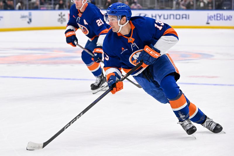 Oct 26, 2024; Elmont, New York, USA;  New York Islanders center Mathew Barzal (13) skates with the puck against the Florida Panthers during the second period at UBS Arena. Mandatory Credit: Dennis Schneidler-Imagn Images