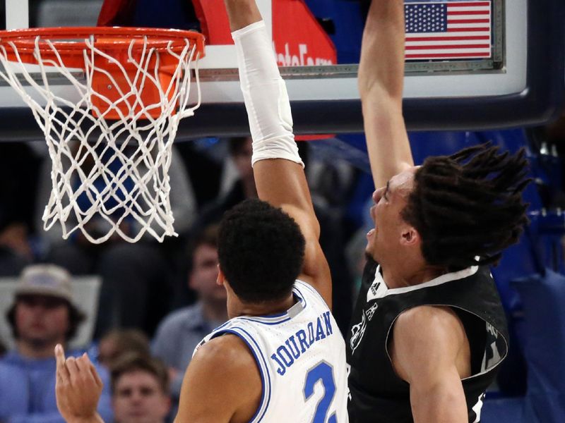 Jan 31, 2024; Memphis, Tennessee, USA; Rice Owls forward Keanu Dawes (24) dunks over Memphis Tigers forward Nicholas Jourdain (2) during the first half at FedExForum. Mandatory Credit: Petre Thomas-USA TODAY Sports